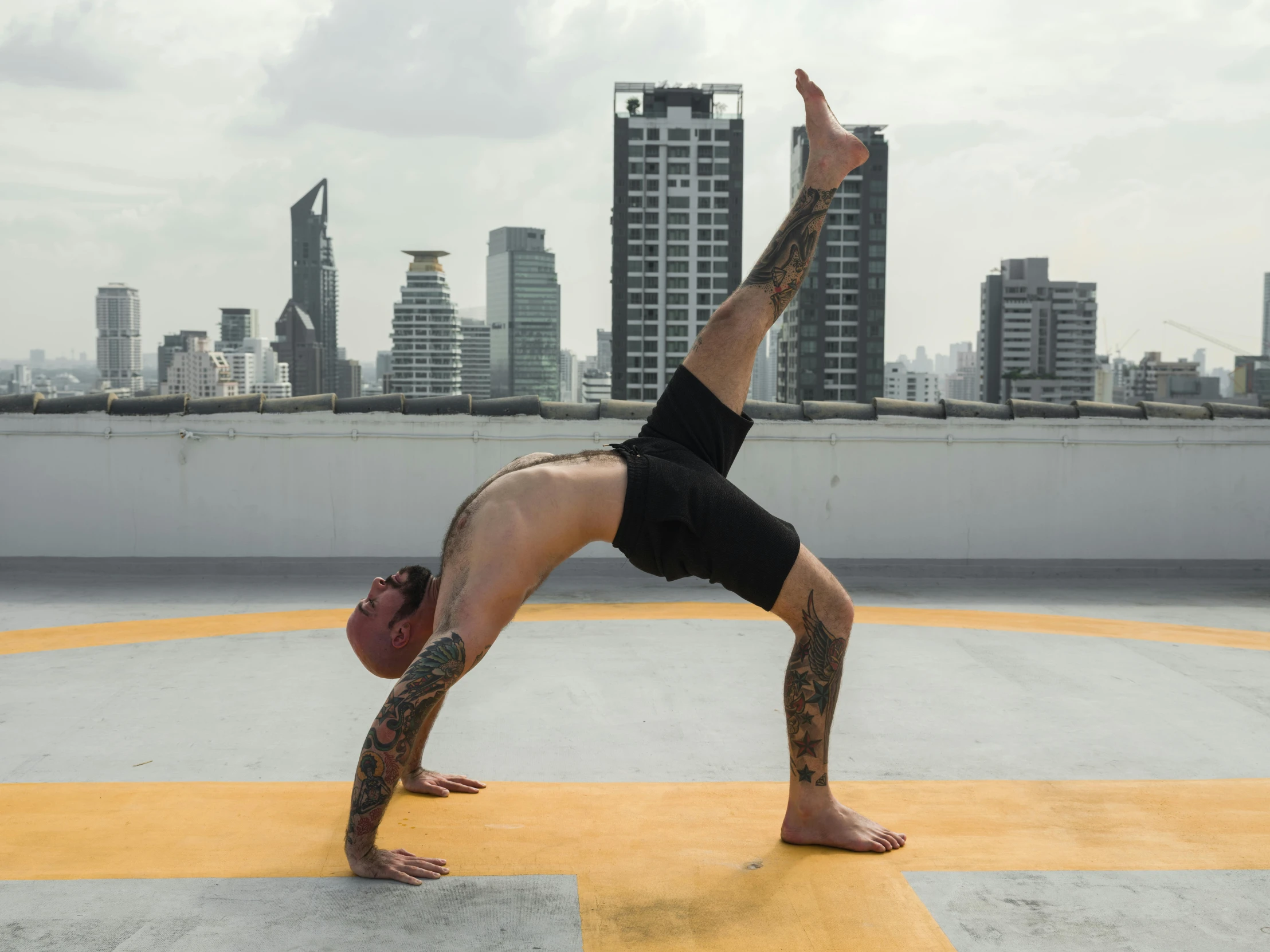 a man doing a handstand on top of a roof, pexels contest winner, arabesque, bangkok, big arches in the back, profile image, marjaryasana and bitilasana