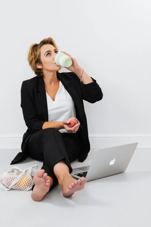 a woman sitting on the floor drinking from a cup, trending on unsplash, office clothes, funny professional photo, transhumanist hydration, profile image