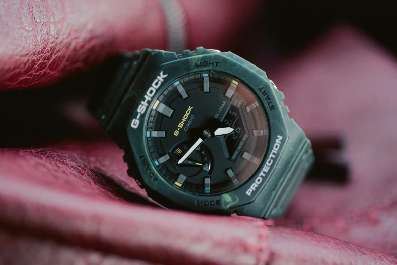 a close up of a watch on a pink cloth, a portrait, by Austin English, unsplash, graffiti, dark green tint, robotech styling, sleek interceptor profile, green: 0.5