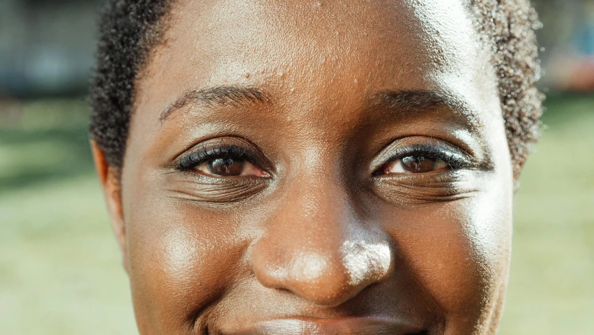 a close up of a woman smiling at the camera, by Carey Morris, hurufiyya, spherical black pupils, oily skin, laura zalenga, super high resolution