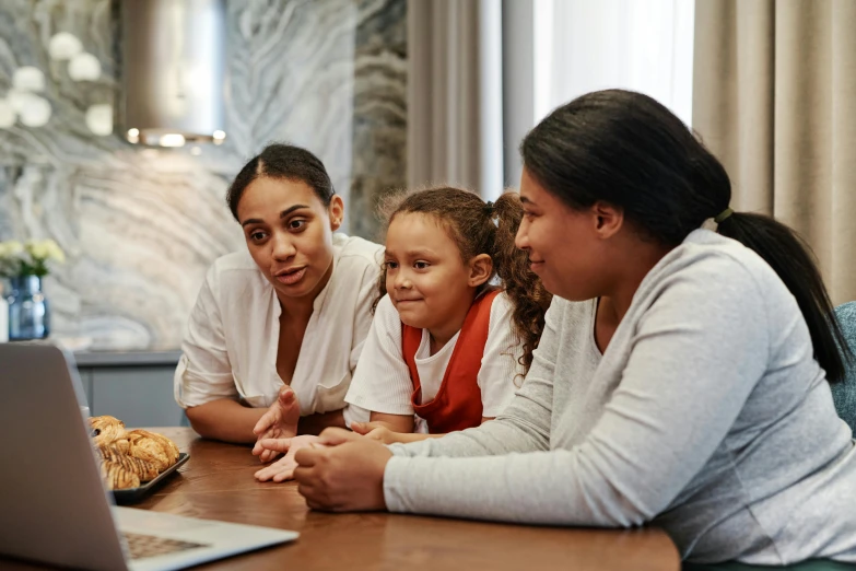 a group of people sitting at a table with a laptop, in a kitchen, profile image, children's, three women