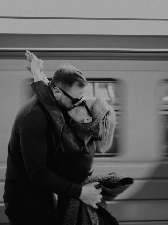 a man and woman kissing in front of a train, by andrei riabovitchev, cinematic. by leng jun, hug, jovana rikalo, sofya emelenko