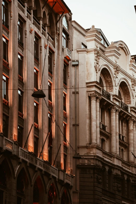 a couple of buildings that are next to each other, pexels contest winner, neoclassicism, brown atmospheric lighting, ivory and copper, buenos aires, italy