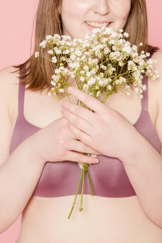 a woman holding a bunch of flowers in front of her face, an album cover, inspired by Elsa Bleda, aestheticism, sports bra, rinko kawauchi, physical : tinyest midriff ever, silicone skin