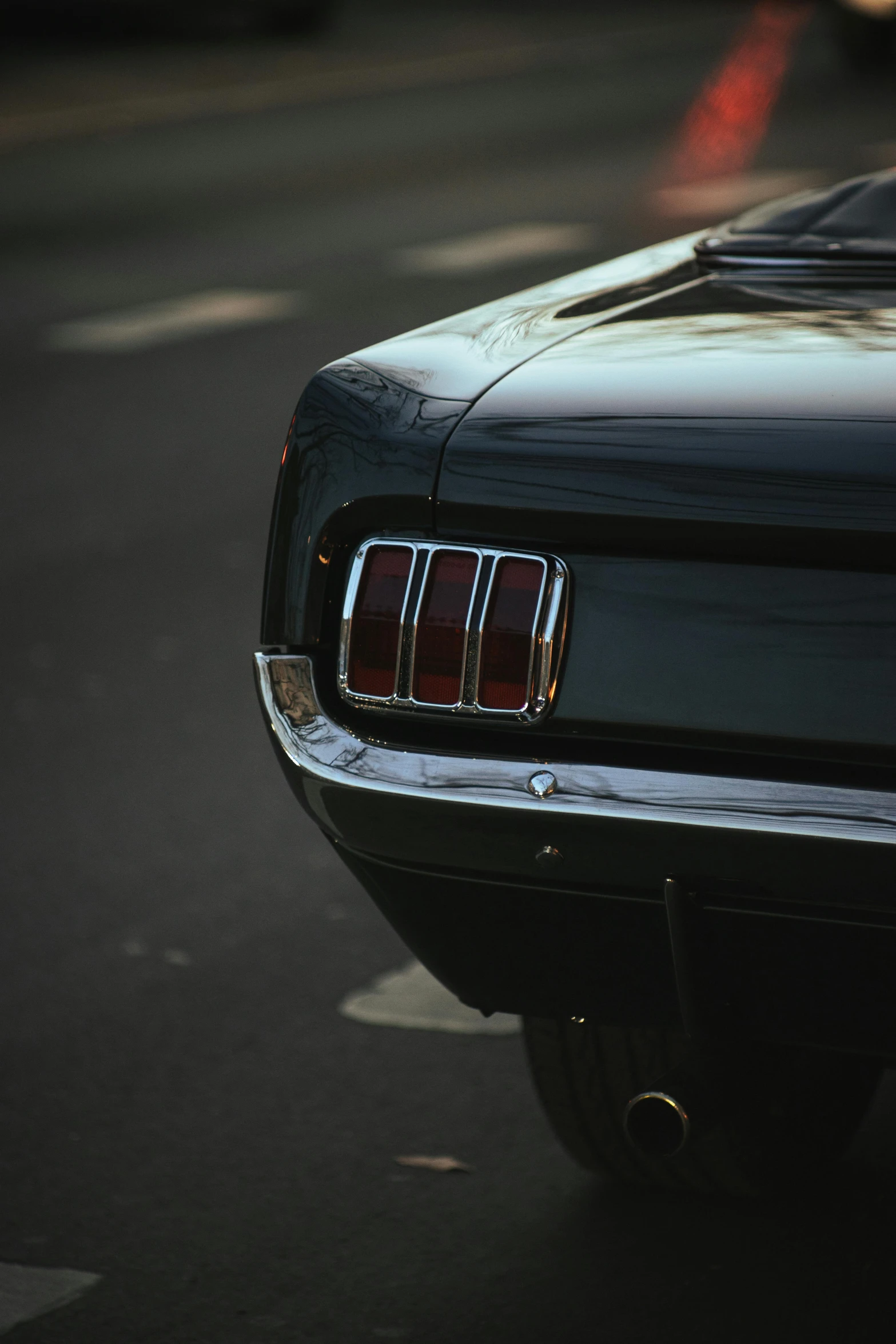 a black mustang parked on the side of the road, pexels contest winner, tail lights, late 1 9 6 0's, bottom body close up, 15081959 21121991 01012000 4k