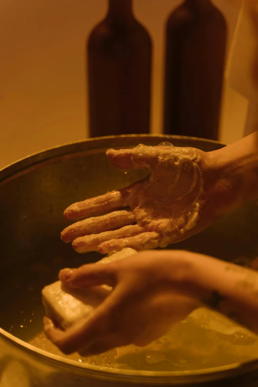 a person washing their hands with soap in a bowl, by Alice Mason, process art, in the evening, palm skin, fine dining, cast