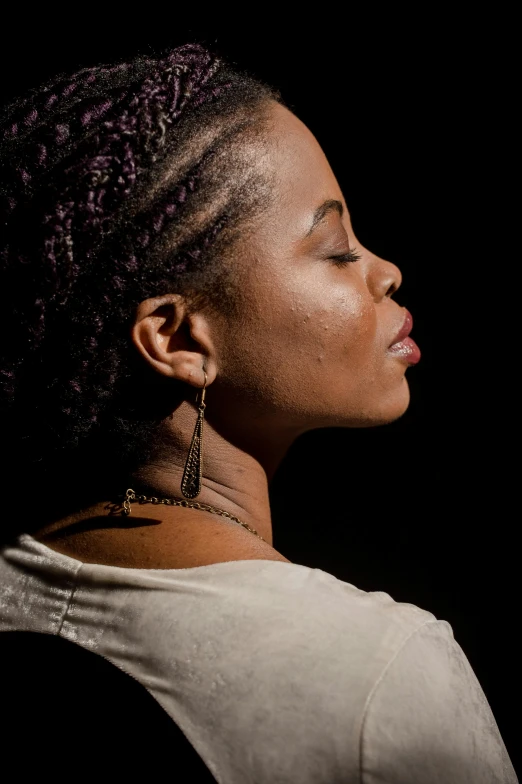 a woman holding a cell phone up to her ear, an album cover, inspired by Makoto Aida, trending on unsplash, black arts movement, soft light from the side, contemplative, profile image, concert