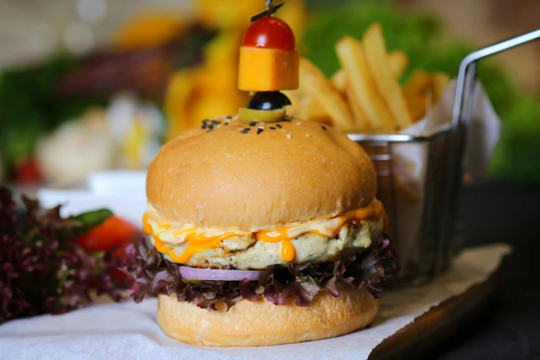 a close up of a hamburger on a plate with fries, unsplash, chicken sandwich, avatar image, cheesy, humus