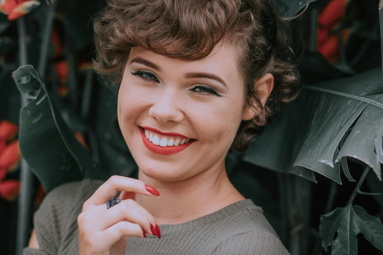 a close up of a person holding a cell phone, a colorized photo, inspired by Dorothy Coke, dark short curly hair smiling, hailee steinfeld, 1 9 4 0 s haircut, youtube thumbnail