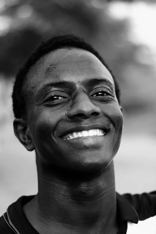 a black and white photo of a man smiling, inspired by Willian Murai, skinny face, smiles and colors, adebanji alade, in 2 0 1 5