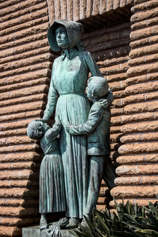 a statue of a woman holding a child, a statue, tucson arizona, the three marys at the sepulchre, at the waterside, on a wall