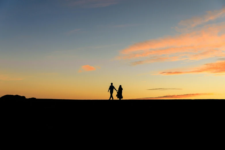 a couple of people standing on top of a hill, by Peter Churcher, pexels contest winner, trailing off into the horizon, romantic, simplistic, early evening