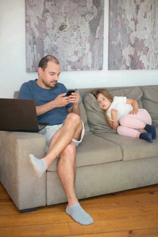 a man sitting on top of a couch next to a little girl, incoherents, in front of the internet, covid, square, high resolution image