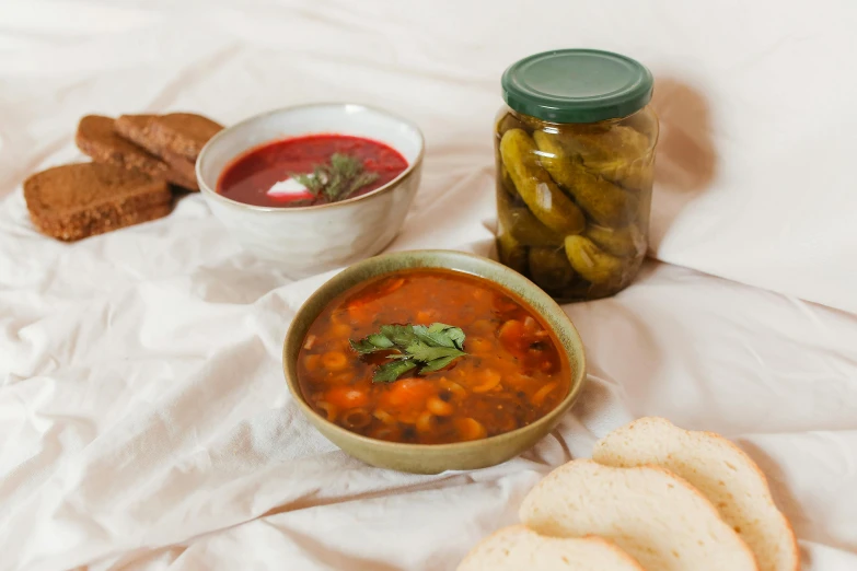 a table topped with bowls of soup and bread, pexels contest winner, bauhaus, pickles, full body image, product image, high resolution image