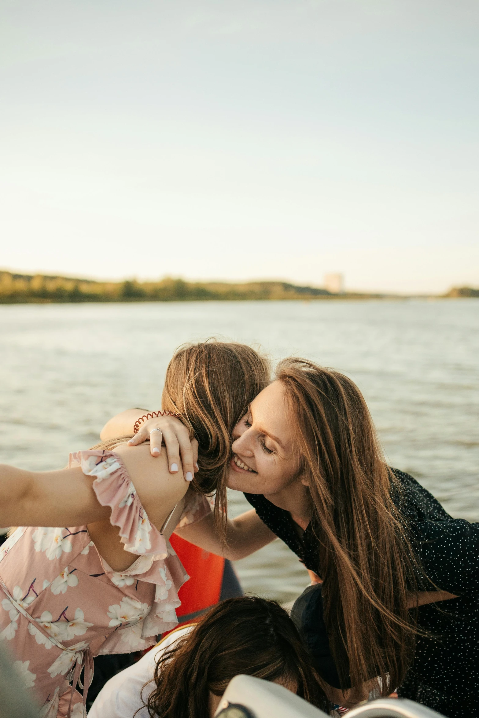 a group of women sitting on top of a boat, by Carey Morris, trending on unsplash, romanticism, portrait of two girls kissing, 15081959 21121991 01012000 4k, headshot, river