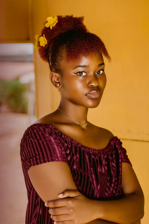 a woman standing in front of a yellow wall, by Chinwe Chukwuogo-Roy, pexels contest winner, renaissance, portrait of teen girl, brown-red-hair pretty face, ((portrait)), grainy