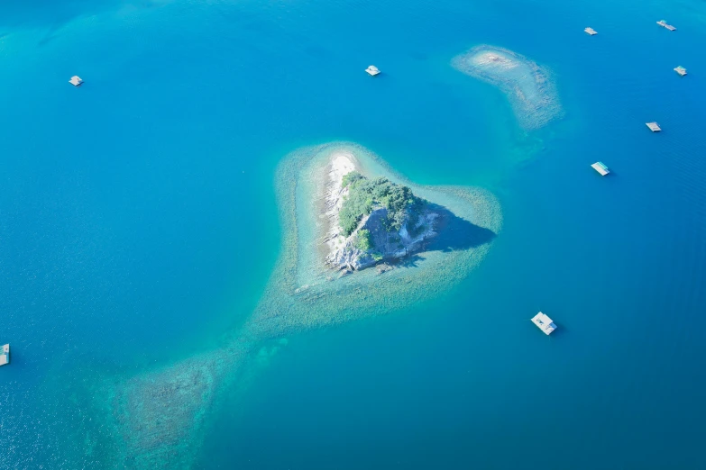 a heart shaped island in the middle of the ocean, by Julian Allen, pexels contest winner, slim aarons, picton blue, trinity, laura sava