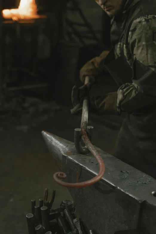 a man working on a piece of metal with a hammer, inspired by Jacob Maris, featured on reddit, movie still from game of thrones, 4k detail post processing, serpent, shot with canon eoa 6 d mark ii