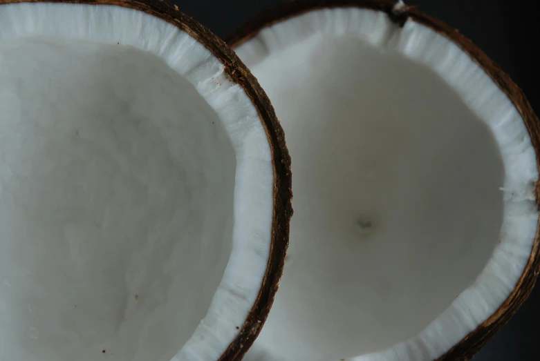 two halves of a coconut sitting next to each other, unsplash, background image, close-up photo, multiple stories, recipe