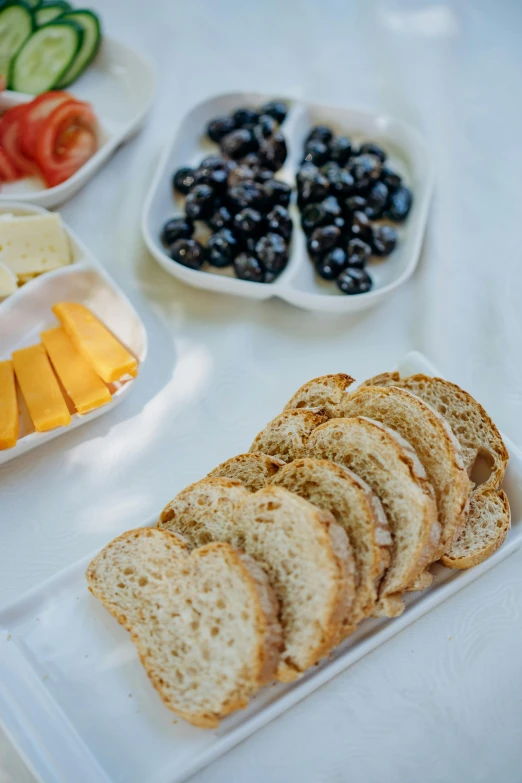 a close up of a plate of food on a table, sliced bread in slots, fruit, cheesy, perfect crisp light