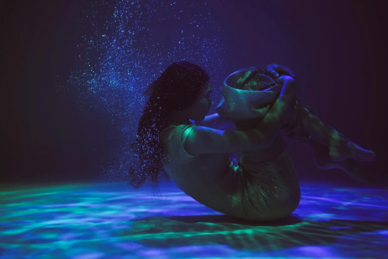 a woman that is sitting down in the water, a hologram, inspired by Elsa Bleda, unsplash contest winner, dancefloor kismet, green and purple studio lighting, sculpture made of water, bottom of the sea