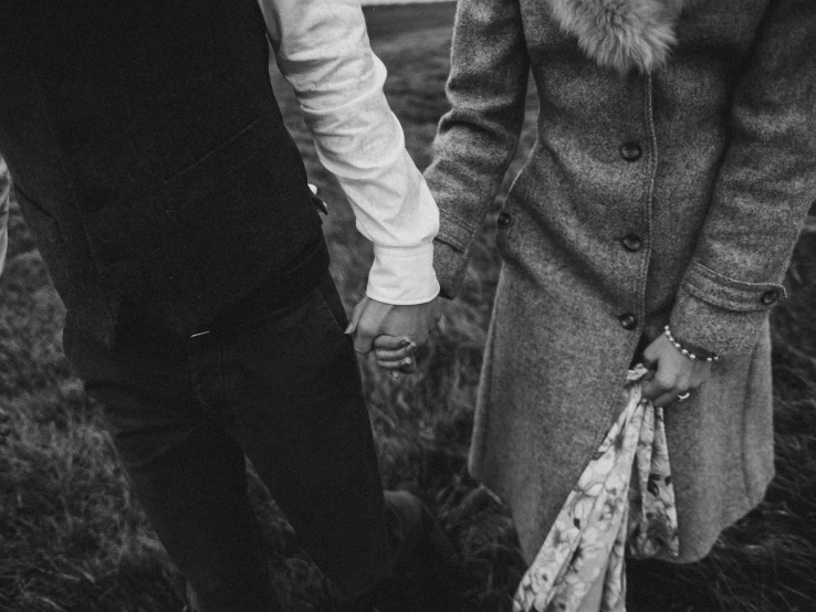 a black and white photo of a couple holding hands, by Emma Andijewska, holding a stuff, 15081959 21121991 01012000 4k, detailed clothing, meadows