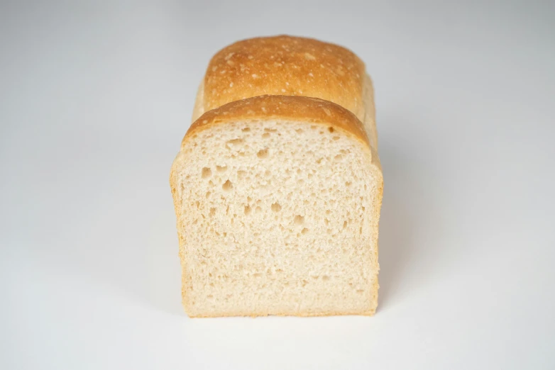 a loaf of bread sitting on top of a white table, detailed product image, eye - level medium - angle shot, frontal shot, portrait n - 9
