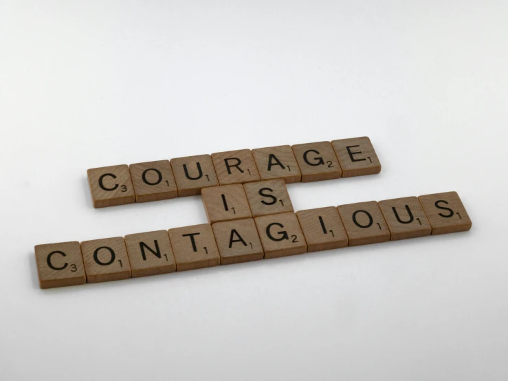 a scrabble that says courage is contagious, by Felicity Charlton, art & language, beige, as photograph