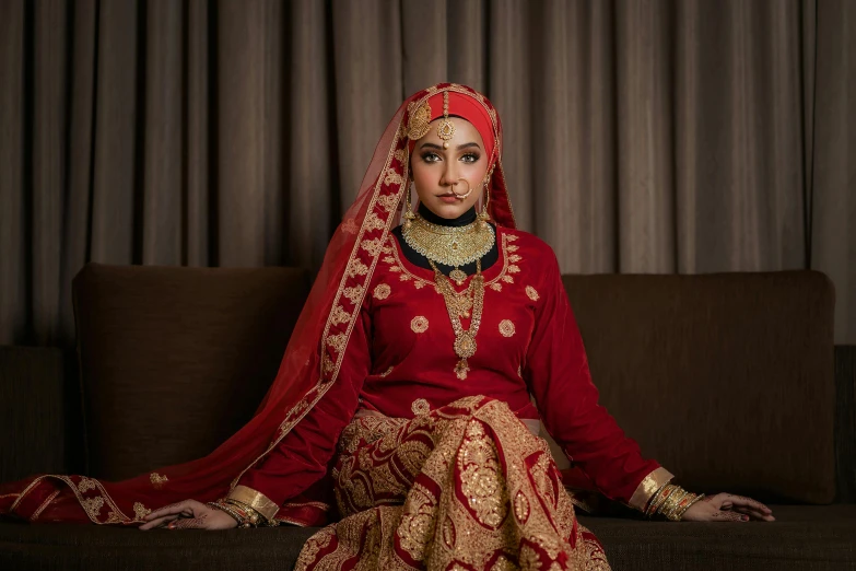 a woman in a red dress sitting on a couch, a portrait, by Basuki Abdullah, pexels contest winner, hurufiyya, wearing authentic attire, bride, square, blank