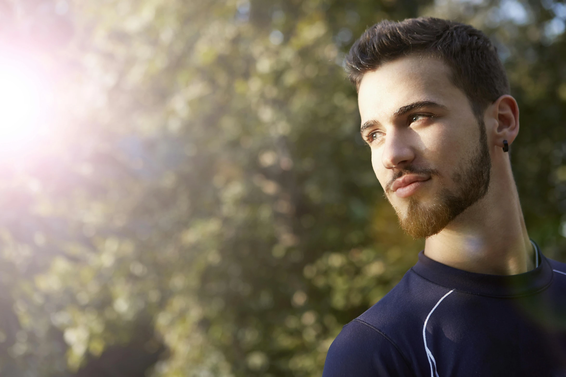 a man with a beard standing in front of trees, shutterstock, 30 year old man :: athletic, backlighted, guillaume tholly, cute young man