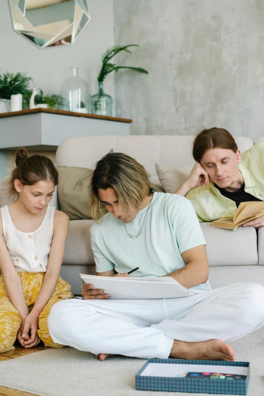 a group of people sitting on the floor in a living room, caring fatherly wide forehead, writing a letter, sitting on the couch, gen z