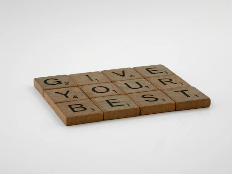 a wooden scrabble with the words give your best written on it, a jigsaw puzzle, inspired by Ian Hamilton Finlay, letterism, brown, grey, calvin klein photograph, reverse