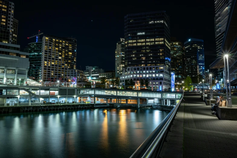 a river running through a city next to tall buildings, by Chris Rallis, pexels contest winner, victorian harbour night, slide show, lachlan bailey, shoreline