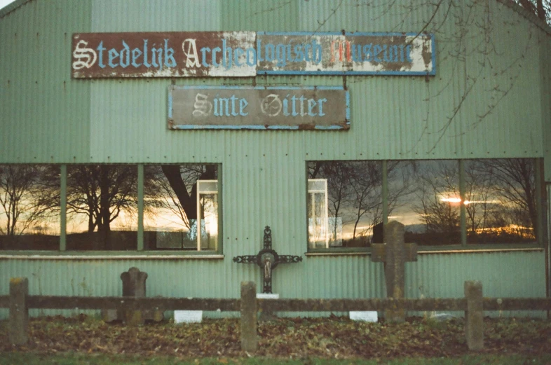 a building with a fire hydrant in front of it, a photo, inspired by Archibald Skirving, aestheticism, smelting pit'beeple, photo 1998, stålenhag, crooked smile