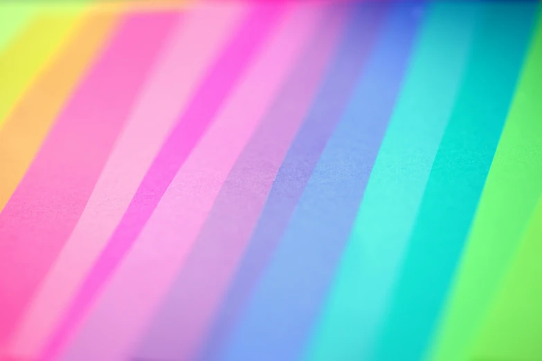 a close up of a rainbow colored background, trending on pexels, rainbow neon strips, shades of pink and blue, paper, colorful signs