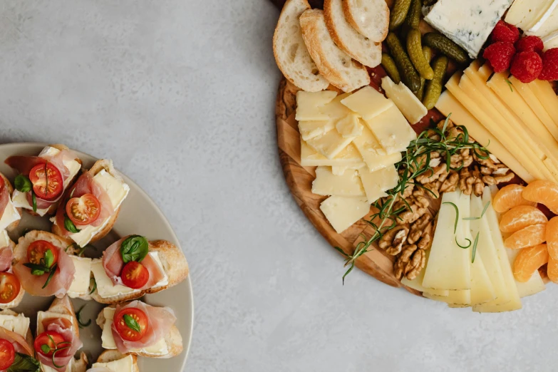 a close up of a plate of food on a table, cheeses, on a gray background, pro - vida, background image