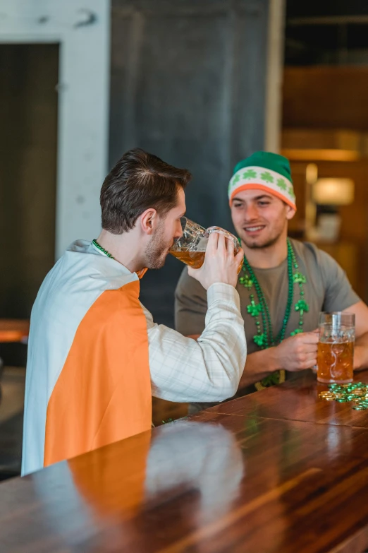 two men sitting at a bar drinking beer, irish genes, green robes, clover, thumbnail