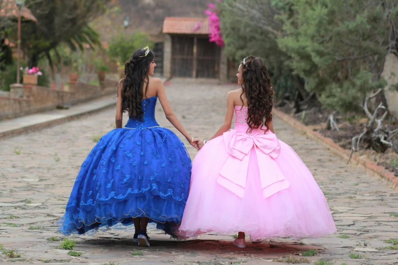 two little girls walking down a cobblestone street, by Lilia Alvarado, pexels, happening, brilliant pink ball gown, beautiful mexican woman, two blue braids, profile pic