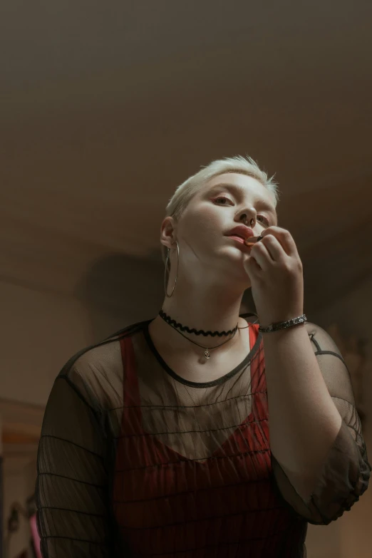 a woman in a red dress talking on a cell phone, an album cover, inspired by Elsa Bleda, trending on pexels, aestheticism, short platinum hair tomboy, intense albino, hand on her chin, young woman looking up