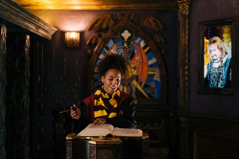 a woman sitting at a table reading a book, inspired by Hermione Hammond, hogwarts gryffindor common room, he is casting a lighting spell, ashteroth, ( ( theatrical ) )