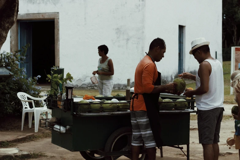 a group of people standing around a food cart, by Ceferí Olivé, unsplash, jungle fruit, square, green alleys, ignant