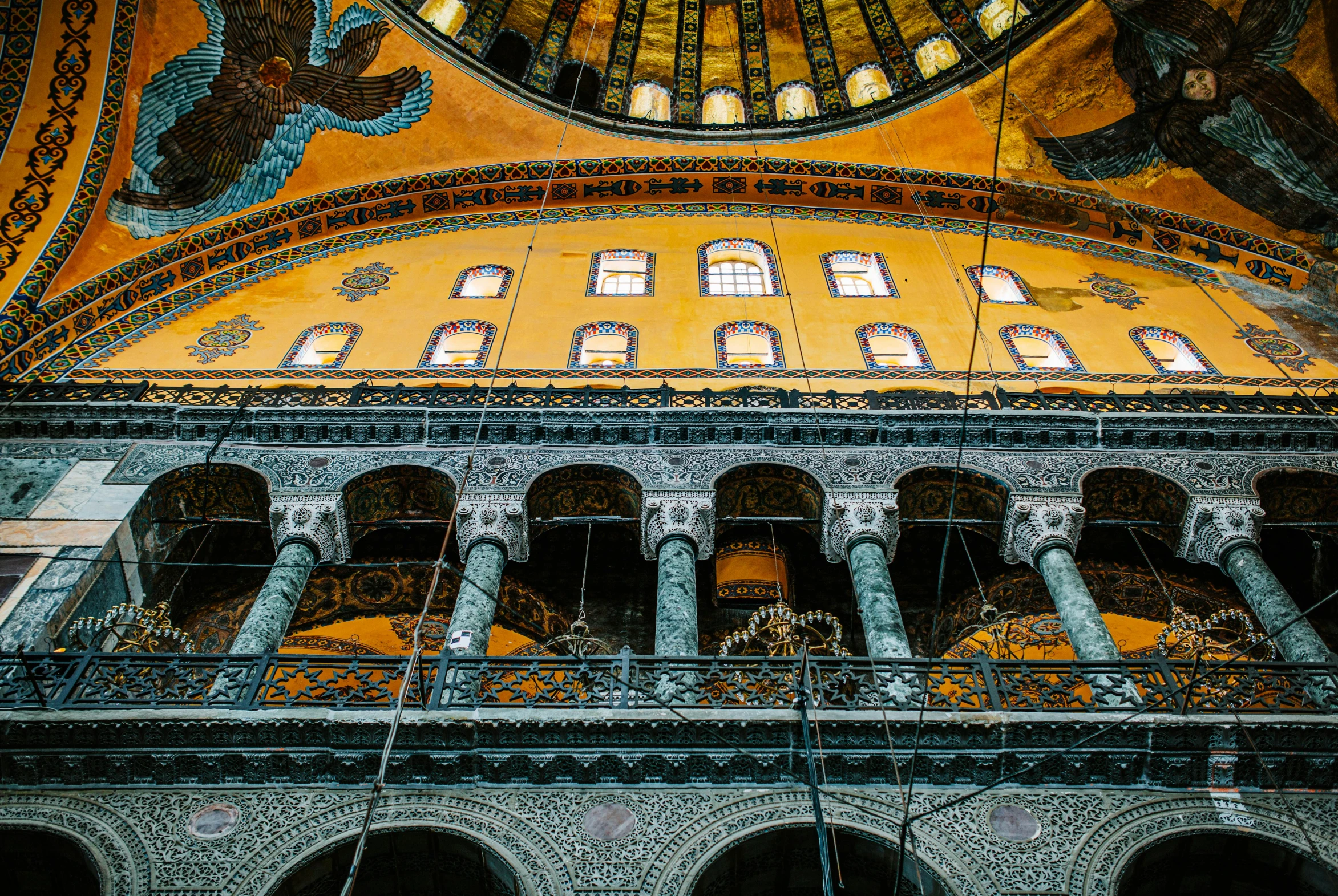 the interior of an ornately decorated building, a mosaic, by Meredith Dillman, pexels contest winner, with great domes and arches, bird view, blue and yellow color theme, profile image