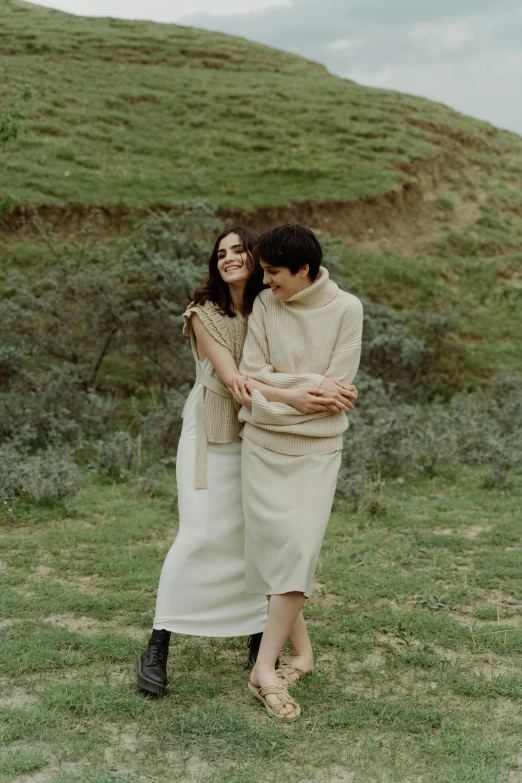 a man and woman standing next to each other in a field, trending on pexels, renaissance, wearing off - white style, lesbian, chile, cosy