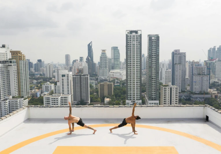 two people doing yoga on top of a building, by Carey Morris, pexels contest winner, bangkok, ouchh and and innate studio, flattened, high rise buildings