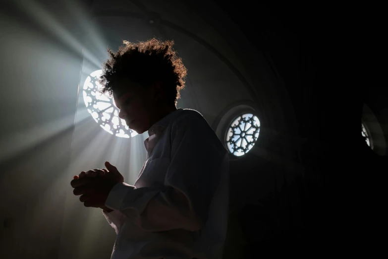 a person that is standing in the dark, hurufiyya, standing in a church, praying at the sun, getty images, fan favorite