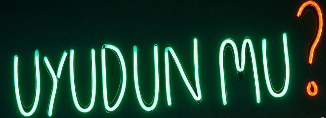 a neon sign with a question mark on it, by Anne Dunn, dune (2021), yung lean, dark green tint, round-cropped