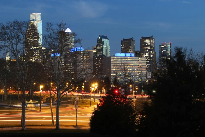 a view of a city at night from a park, a photo, always sunny in philadelphia, college, high res photograph, 8k resolution”