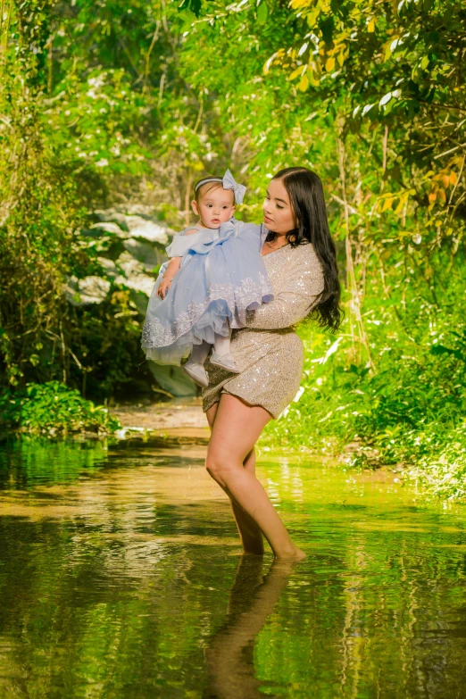 a woman holding a baby in a river, a portrait, by Matt Cavotta, art photography, full body length, plus size, glitter, 15081959 21121991 01012000 4k