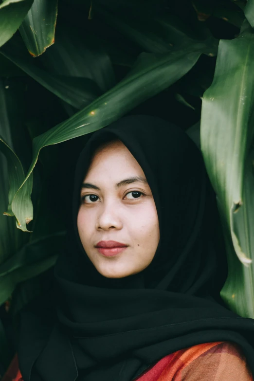 a close up of a person wearing a headscarf, inspired by Bernardino Mei, unsplash contest winner, sitting on a leaf, portrait symetrical, indonesia, black and green