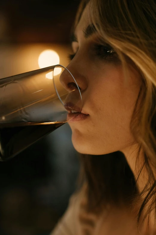 a woman drinking a glass of red wine, a portrait, pexels, ultra realistic. cinematic, 2 0 yo, up-close, movie filmstill